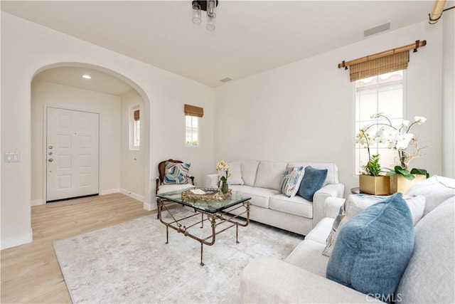 29 Windchime, Irvine, CA 92603 - living area featuring arched walkways and light wood-style flooring