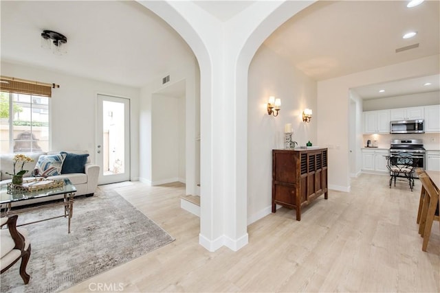 29 Windchime, Irvine, CA 92603 - living room with arched walkways, light wood-type flooring, and recessed lighting