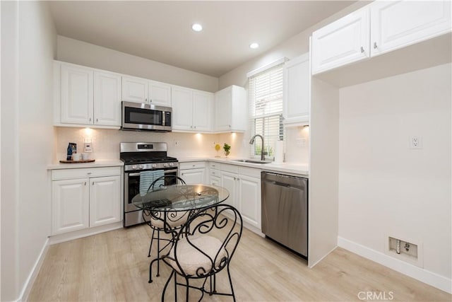 29 Windchime, Irvine, CA 92603 - kitchen featuring stainless steel appliances, light wood finished floors, light countertops, white cabinetry, and recessed lighting