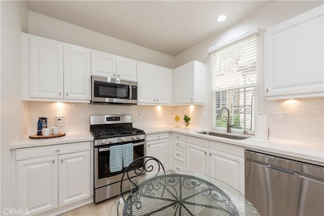 29 Windchime, Irvine, CA 92603 - kitchen featuring stainless steel appliances, white cabinets, decorative backsplash, and recessed lighting