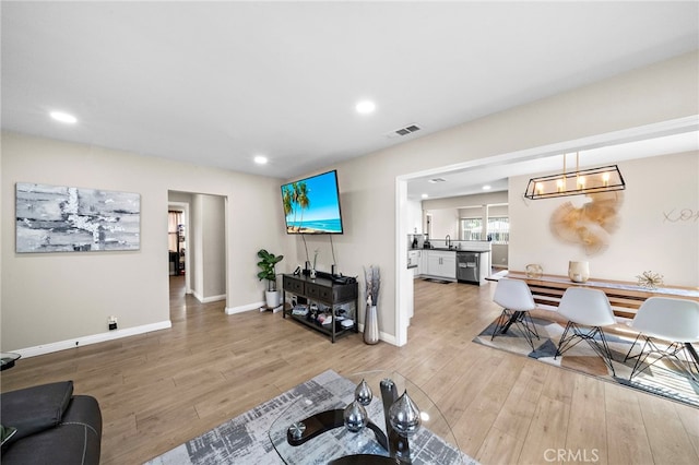 2729 Fairman St, Lakewood, CA 90712 - living area featuring light wood-style flooring and recessed lighting
