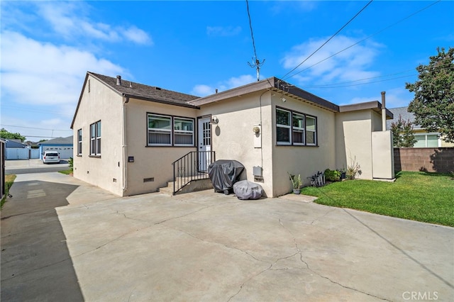 2729 Fairman St, Lakewood, CA 90712 - back of property featuring stucco siding, crawl space, and concrete driveway