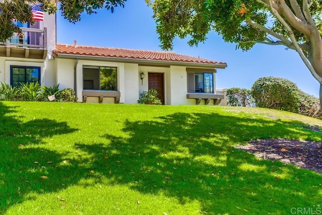 6942 Batiquitos, Carlsbad, CA 92011 - view of front of property featuring a tiled roof, a front yard, and stucco siding
