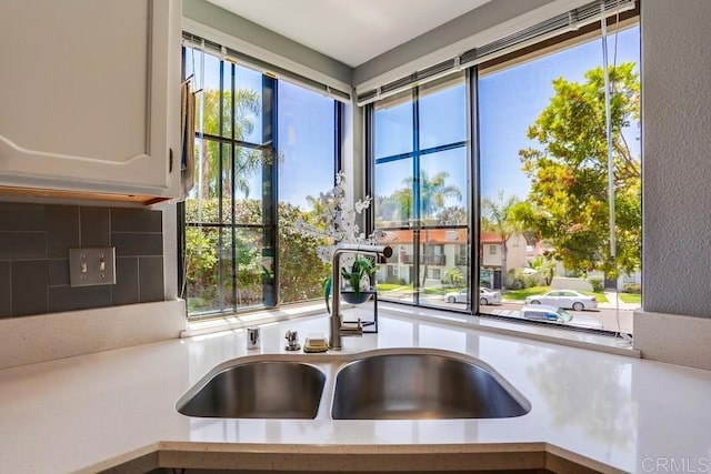 6942 Batiquitos, Carlsbad, CA 92011 - kitchen view of light countertops, white cabinetry, and tasteful backsplash