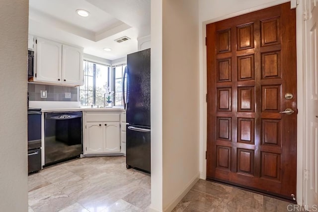 6942 Batiquitos, Carlsbad, CA 92011 - kitchen featuring black appliances, white cabinetry, light countertops, a raised ceiling, and recessed lighting