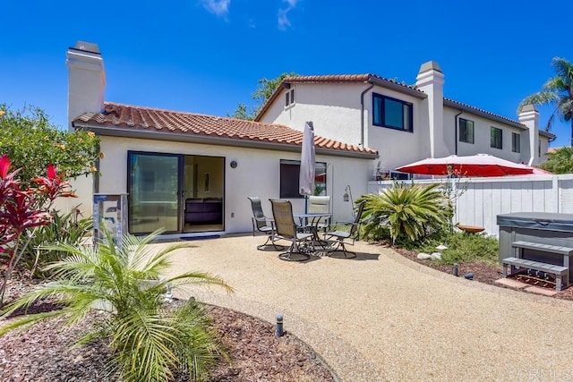 6942 Batiquitos, Carlsbad, CA 92011 - back of property with a patio area, stucco siding, a tile roof, and a chimney