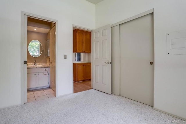 6942 Batiquitos, Carlsbad, CA 92011 - unfurnished bedroom featuring a closet, connected bathroom, and light colored carpet
