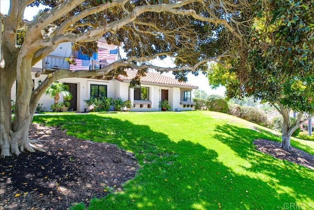 6942 Batiquitos, Carlsbad, CA 92011 - view of front of house featuring a front yard and stucco siding
