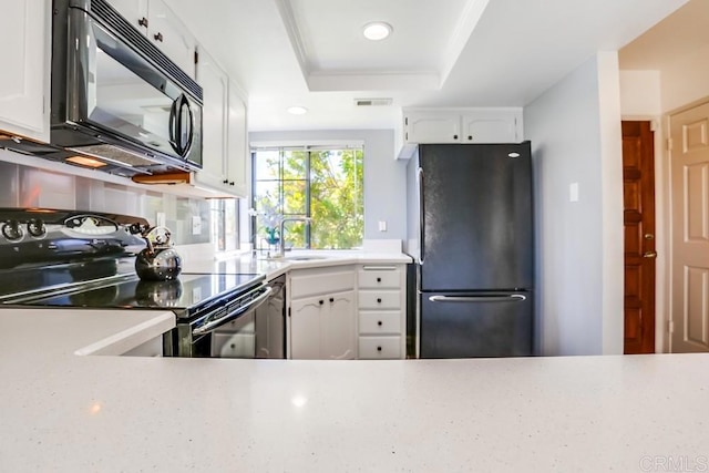 6942 Batiquitos, Carlsbad, CA 92011 - kitchen featuring black appliances, a raised ceiling, white cabinetry, light countertops, and recessed lighting