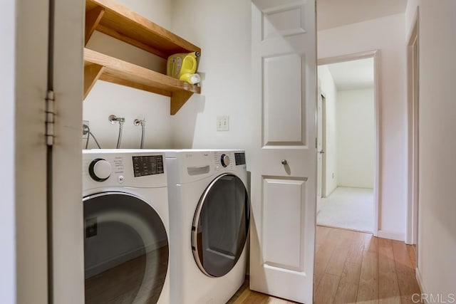 6942 Batiquitos, Carlsbad, CA 92011 - washroom with washer and clothes dryer and light wood-style floors