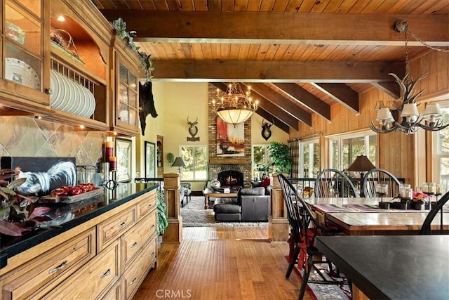 207 N Fairway Dr N, Lake Arrowhead, CA 92391 - dining area featuring a chandelier, wood ceiling, a brick fireplace, and dark wood-style floors
