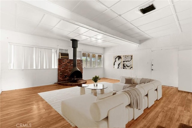 1450 Pepper Tree Ln, San Bernardino, CA 92404 - living room with a wood stove and light wood-style flooring