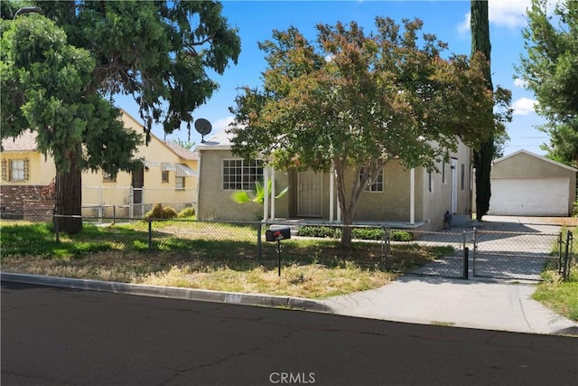 549 E Evans St, San Bernardino, CA 92404 - view of property hidden behind natural elements with stucco siding, an outdoor structure, a garage, and a fenced front yard