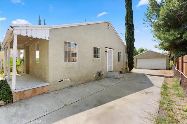 549 E Evans St, San Bernardino, CA 92404 - back of property featuring stucco siding, entry steps, a garage, an outdoor structure, and crawl space