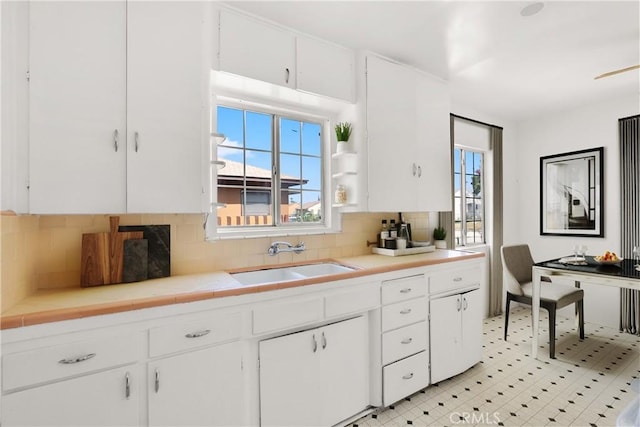 549 E Evans St, San Bernardino, CA 92404 - kitchen featuring white cabinets and plenty of natural light