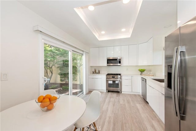 10 Windsong, Irvine, CA 92614 - kitchen with appliances with stainless steel finishes, modern cabinets, light countertops, white cabinetry, and recessed lighting