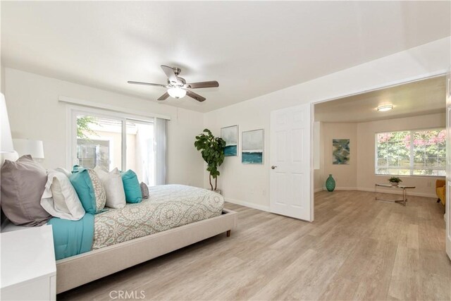10 Windsong, Irvine, CA 92614 - bedroom with light wood finished floors, multiple windows, and a ceiling fan