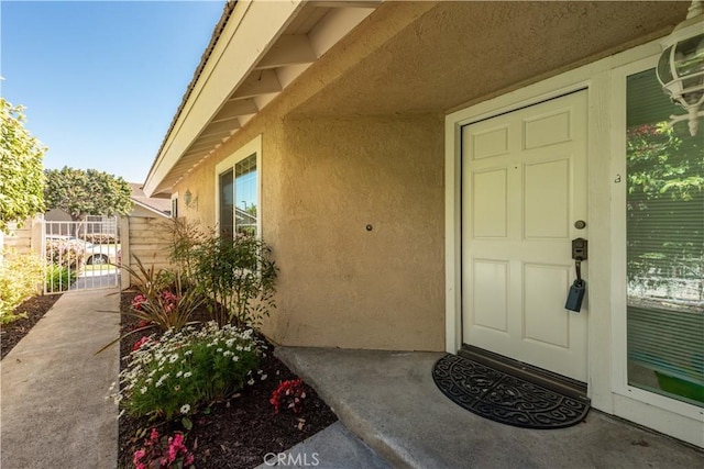 10 Windsong, Irvine, CA 92614 - doorway to property featuring stucco siding