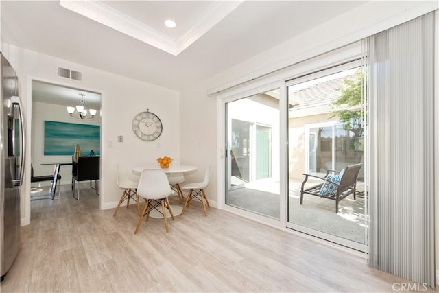 10 Windsong, Irvine, CA 92614 - dining room featuring light wood-type flooring, crown molding, a raised ceiling, a chandelier, and recessed lighting