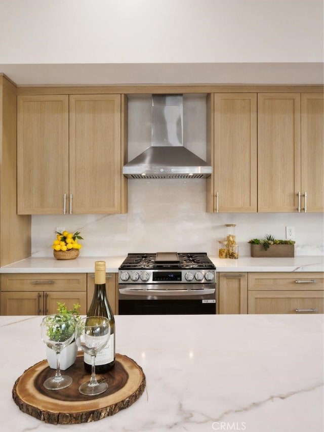 3518 W 228th St, Torrance, CA 90505 - kitchen featuring wall chimney range hood, stainless steel range with gas stovetop, light brown cabinetry, and light countertops