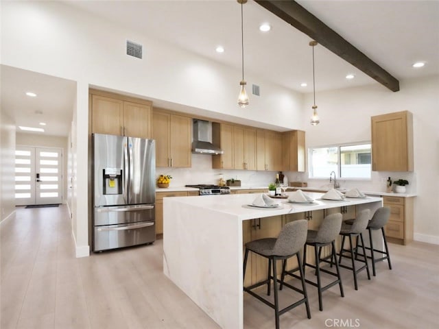 3518 W 228th St, Torrance, CA 90505 - kitchen with stainless steel refrigerator with ice dispenser, wall chimney range hood, a large island, beamed ceiling, and light wood finished floors