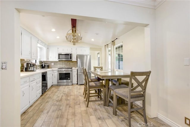 467 W Casad St, Covina, CA 91723 - kitchen featuring stainless steel appliances, tasteful backsplash, white cabinets, light countertops, and lofted ceiling