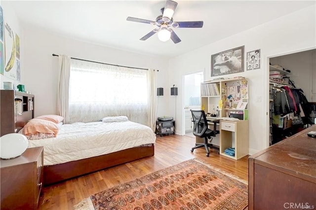 22329 Plummer St, Chatsworth, CA 91311 - bedroom with wood finished floors, an office area, a walk in closet, ceiling fan, and a closet