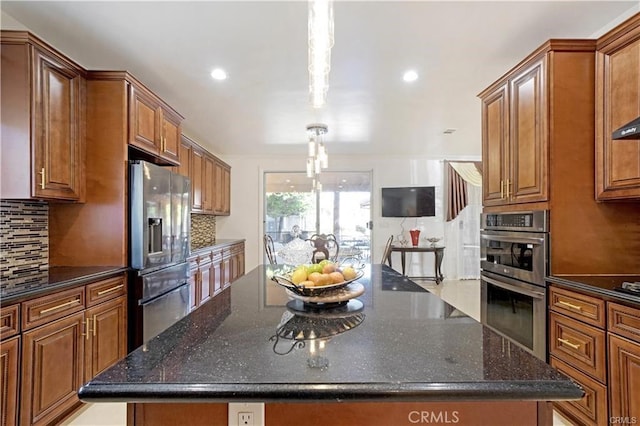 22329 Plummer St, Chatsworth, CA 91311 - kitchen with stainless steel appliances, decorative backsplash, brown cabinetry, a kitchen island, and recessed lighting