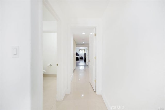 22329 Plummer St, Chatsworth, CA 91311 - corridor featuring light tile patterned flooring and baseboards