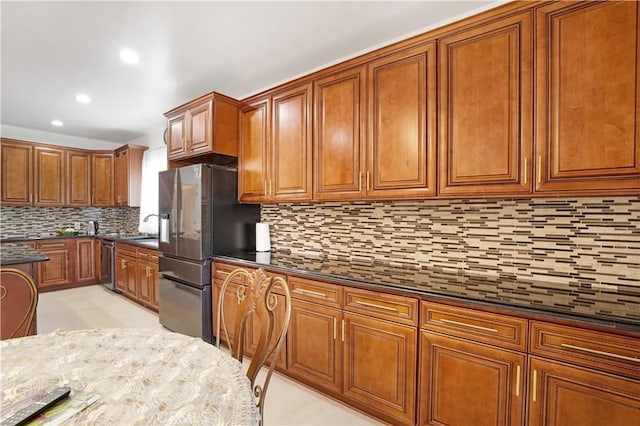 22329 Plummer St, Chatsworth, CA 91311 - kitchen featuring stainless steel appliances, brown cabinetry, decorative backsplash, recessed lighting, and dark stone counters