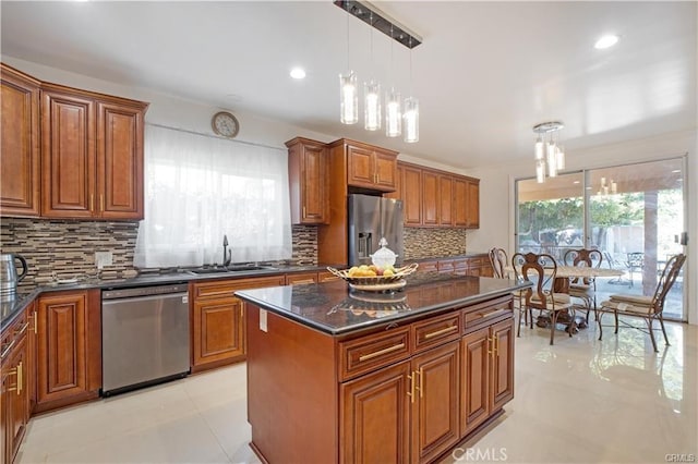 22329 Plummer St, Chatsworth, CA 91311 - kitchen featuring appliances with stainless steel finishes, brown cabinetry, tasteful backsplash, decorative light fixtures, and recessed lighting