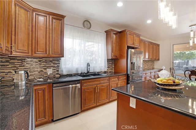 22329 Plummer St, Chatsworth, CA 91311 - kitchen featuring stainless steel appliances, brown cabinets, decorative backsplash, dark stone counters, and recessed lighting