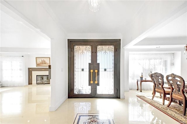 22329 Plummer St, Chatsworth, CA 91311 - foyer featuring french doors, crown molding, plenty of natural light, and a glass covered fireplace