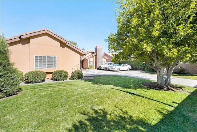 22329 Plummer St, Chatsworth, CA 91311 - view of side of property with a lawn and stucco siding