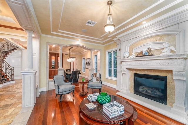 919 S Gretna Green Way, Los Angeles, CA 90049 - living room with decorative columns, stairs, a fireplace, hardwood / wood-style floors, and crown molding