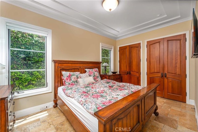 919 S Gretna Green Way, Los Angeles, CA 90049 - bedroom featuring stone tile floors, crown molding, and two closets