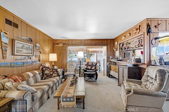 15043 Tuba St, San Fernando, CA 91345 - living area featuring wooden walls and light colored carpet