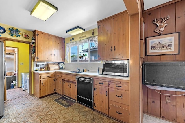 15043 Tuba St, San Fernando, CA 91345 - kitchen with black dishwasher, stainless steel microwave, light countertops, decorative backsplash, and light flooring