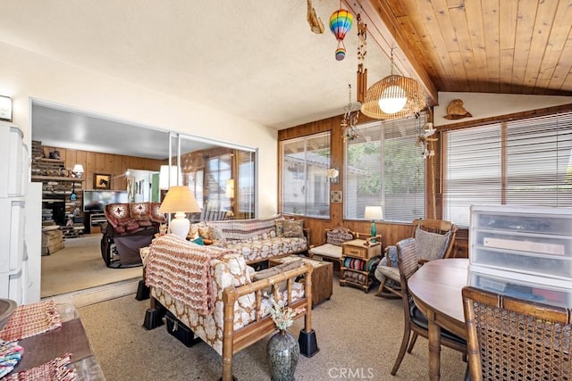 15043 Tuba St, San Fernando, CA 91345 - living area featuring a fireplace, wood walls, light carpet, and vaulted ceiling
