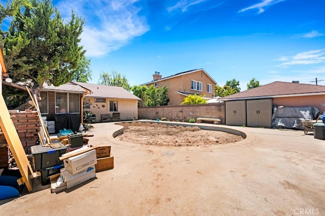 15043 Tuba St, San Fernando, CA 91345 - fenced backyard featuring a storage shed, a patio area, and a sunroom