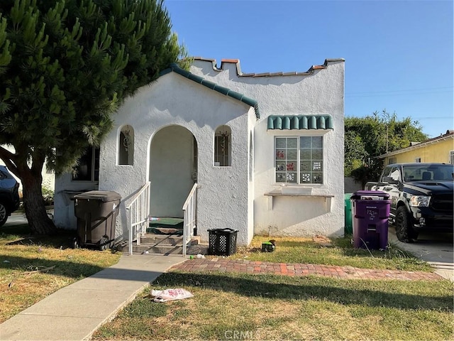 1330 E 56th St, Long Beach, CA 90805 - mediterranean / spanish-style house with stucco siding and a front yard