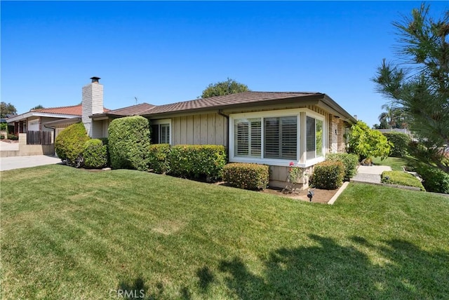 1225 Carlsbad St, Placentia, CA 92870 - view of front of house with a front lawn and a chimney