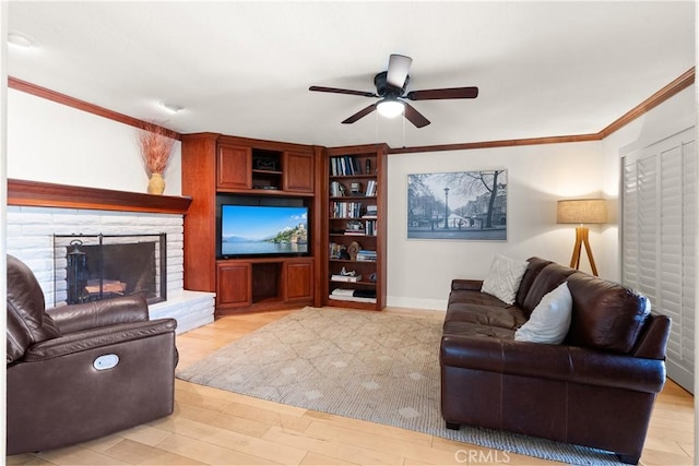 1225 Carlsbad St, Placentia, CA 92870 - living room featuring a ceiling fan, ornamental molding, light wood finished floors, and a fireplace with raised hearth