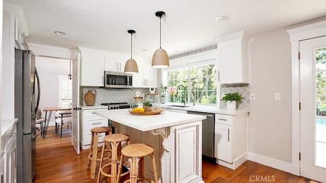 23782 Lagarto, Mission Viejo, CA 92691 - kitchen with stainless steel appliances, light countertops, a breakfast bar area, backsplash, and recessed lighting