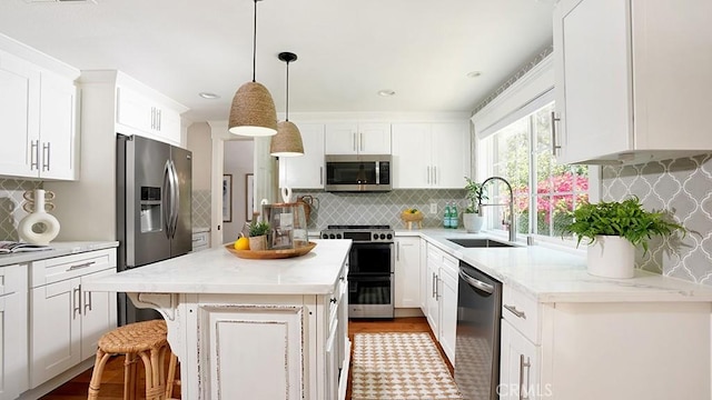 23782 Lagarto, Mission Viejo, CA 92691 - kitchen with appliances with stainless steel finishes, tasteful backsplash, and white cabinetry
