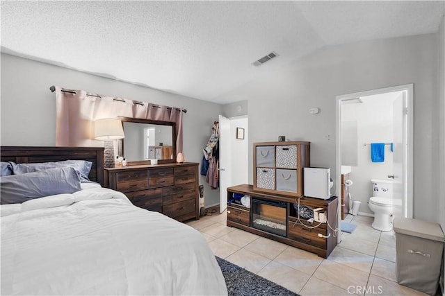 12268 Pluto Dr, Victorville, CA 92392 - bedroom featuring lofted ceiling, light tile patterned floors, and ensuite bathroom
