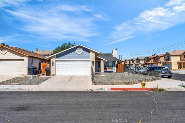 12268 Pluto Dr, Victorville, CA 92392 - ranch-style house featuring a fenced front yard, a garage, driveway, a residential view, and a chimney