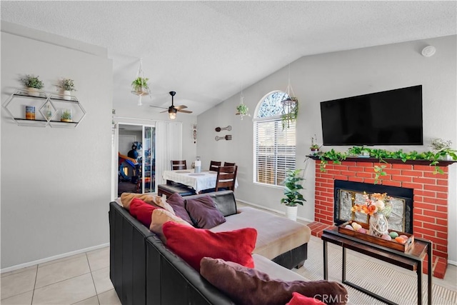 12268 Pluto Dr, Victorville, CA 92392 - living area featuring lofted ceiling, a ceiling fan, light tile patterned floors, a fireplace, and a textured ceiling