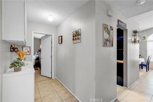 12268 Pluto Dr, Victorville, CA 92392 - hallway featuring a textured ceiling and light tile patterned floors