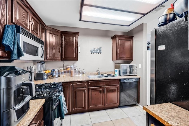 12268 Pluto Dr, Victorville, CA 92392 - kitchen featuring black appliances, light countertops, light tile patterned flooring, and dark brown cabinetry